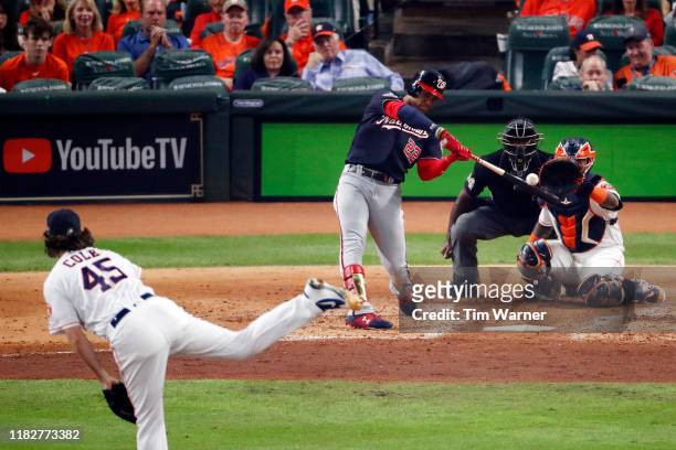 Juan Soto of the Washington Nationals hits a solo home run on a pitch from Gerrit Cole of the Houston Astros during the fourth inning in Game One of...