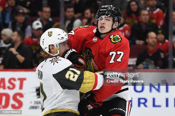 Kirby Dach of the Chicago Blackhawks collides with Cody Eakin of the Vegas Golden Knights during the third period at the United Center on October 22,...