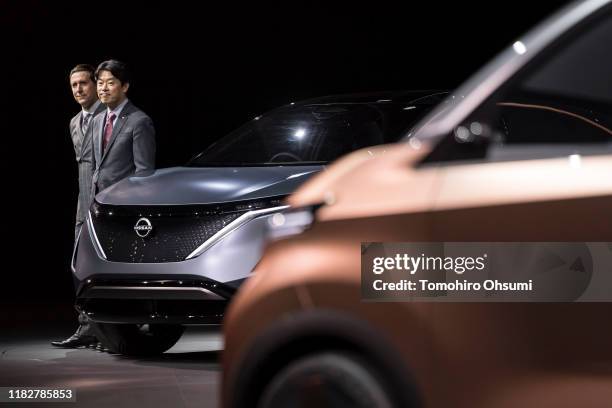Nissan Motor Co. Senior Vice President for Global Design Alfonso Albaisa and Senior Vice President Kunio Nakaguro pose with the company's Ariya...