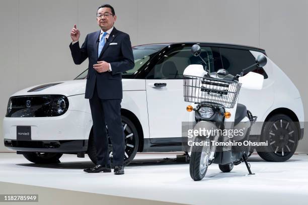 Honda Motor Co. President Takahiro Hachigo speaks in front of the company's Honda E electric vehicle during a press conference at the Tokyo Motor...