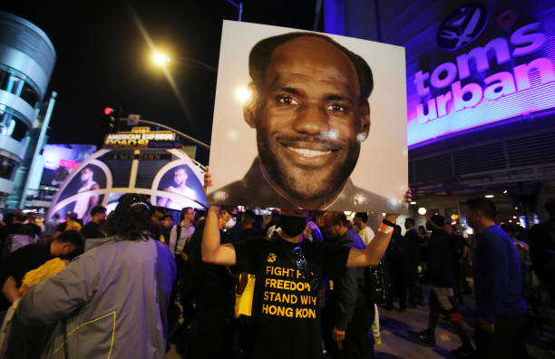 Pro-Hong Kong activist holds an image depicting LeBron James as Chinese communist revolutionary Chairman Mao Zedong before the Los Angeles Lakers...