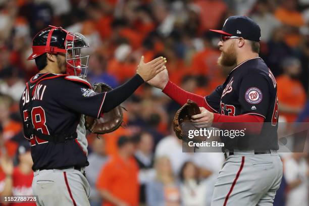 Kurt Suzuki and Sean Doolittle of the Washington Nationals celebrate their 5-4 win over the Houston Astros in Game One of the 2019 World Series at...