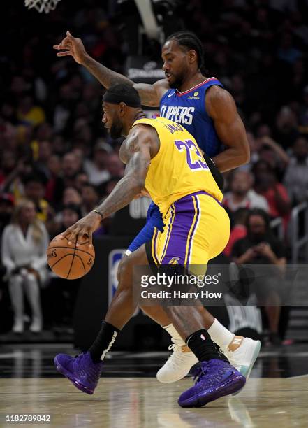 LeBron James of the Los Angeles Lakers drives on Kawhi Leonard of the LA Clippers during the first half in the LA Clippers season home opener at...