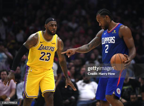 Kawhi Leonard of the LA Clippers controls possession of the ball in front of LeBron James of the Los Angeles Lakers late in the fourth quarter in a...