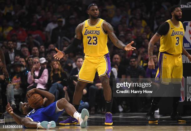 LeBron James of the Los Angeles Lakers reacts to his foul with Anthony Davis on Kawhi Leonard of the LA Clippers during the fourth quarter in a...