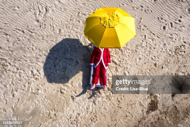 aerial view of santa claus relaxing on the beach. - (position) stock pictures, royalty-free photos & images