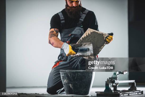 laying a tile floor - dirty construction worker stock pictures, royalty-free photos & images