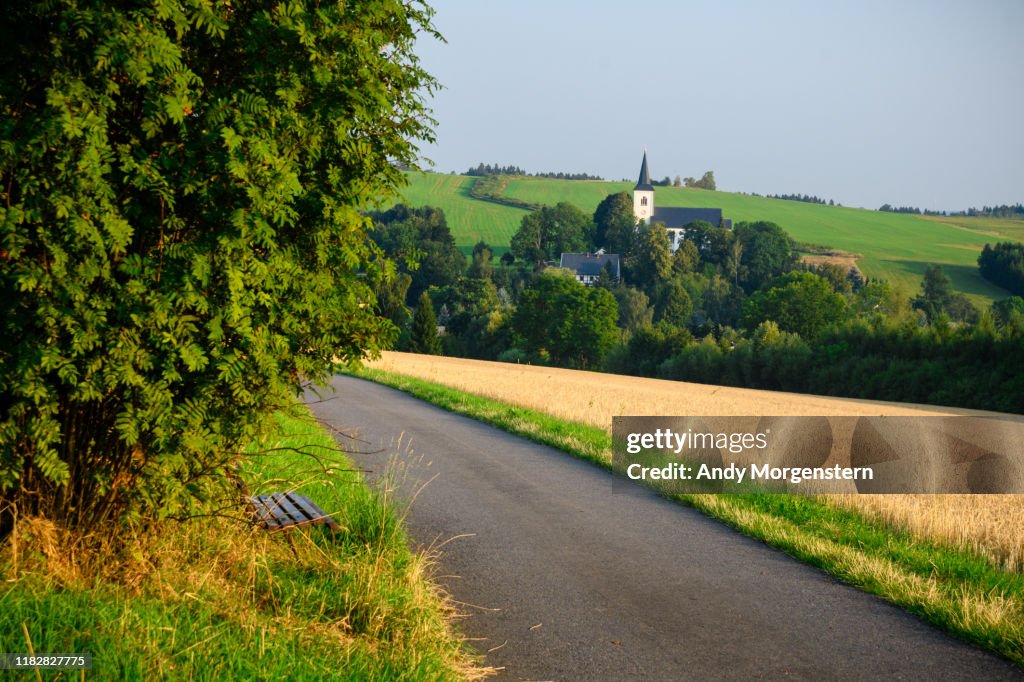 Road to village with church