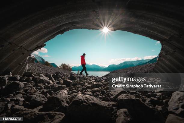 men at secret cave canada abraham lake - asian landscape foto e immagini stock