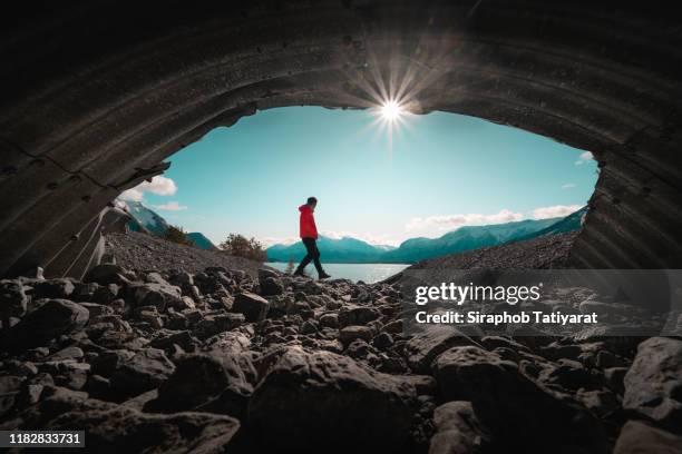 men at secret cave canada abraham lake - wide shot stock pictures, royalty-free photos & images