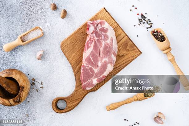 fresh raw pork meat with peppercorns, seasonings and spices, ready to grill. top view - cut of meat stock pictures, royalty-free photos & images