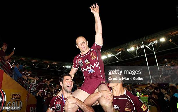 Darren Lockyer of the Maroons is chaired from the field by Cameron Smith and Ashley Harrison of the Maroons after his final state of origin match...