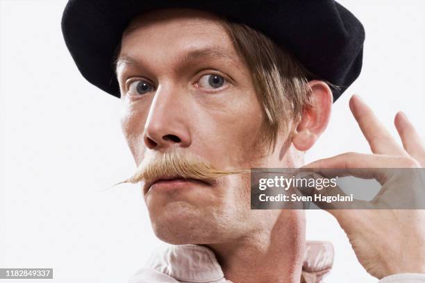 a man twisting his mustache - pinching stock pictures, royalty-free photos & images