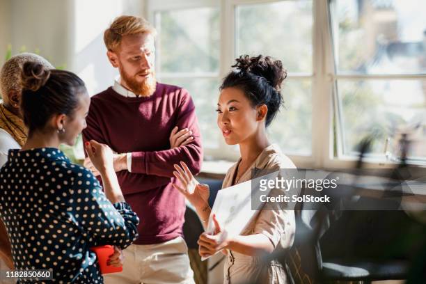discussing business with colleagues - small group of people stock pictures, royalty-free photos & images