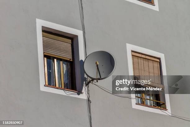 two windows and satellite dish - satellite dish bildbanksfoton och bilder