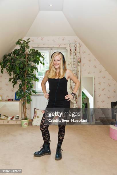 a punk teenage girl standing in a conservatively decorated bedroom - teen girls in tights stock-fotos und bilder