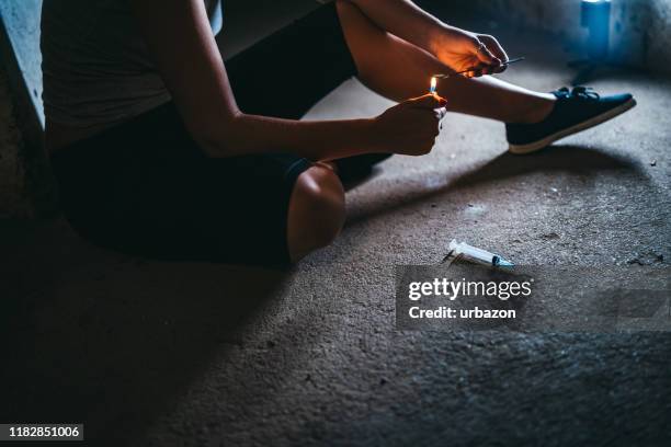 female addict preparing heroin dose - crack spoon stock pictures, royalty-free photos & images