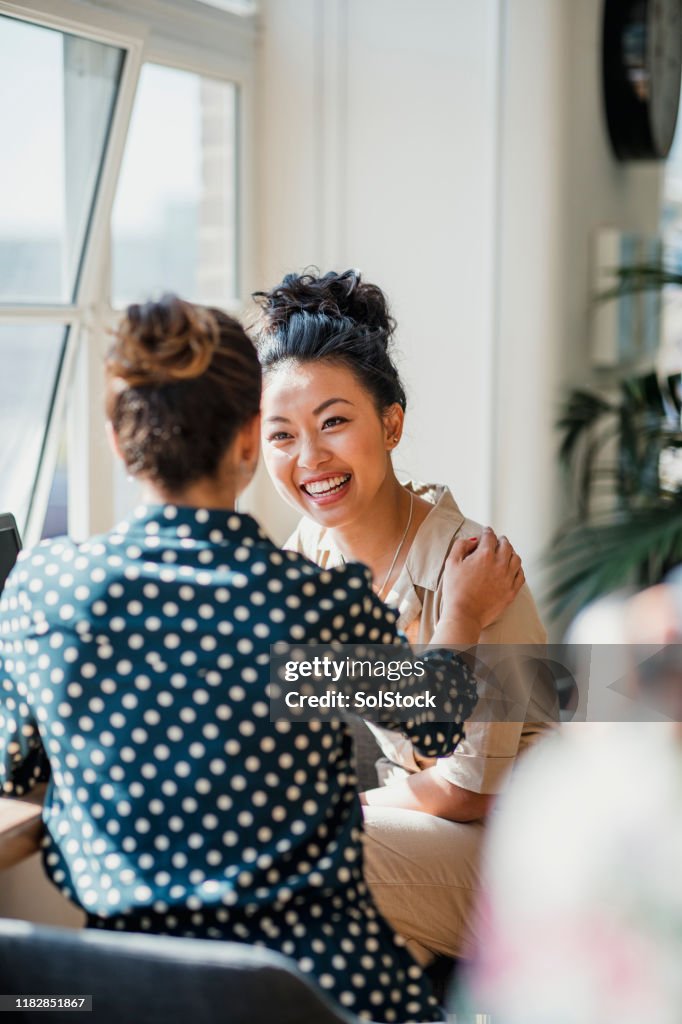 Two Friends Talking at Work