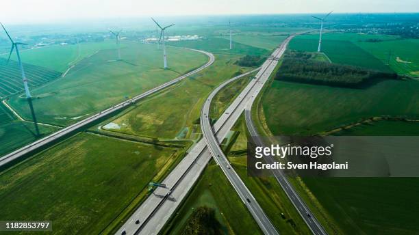 aerial view of highways by wind turbines on field, berlin, brandenburg, germany - tipo di trasporto foto e immagini stock