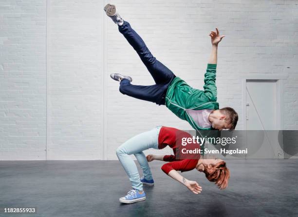 modern aerialist dancers performing - man flying stockfoto's en -beelden