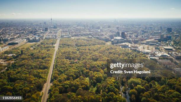 drone point of view sunny tiergarten park and berlin cityscape, germany - berlin aerial stock pictures, royalty-free photos & images