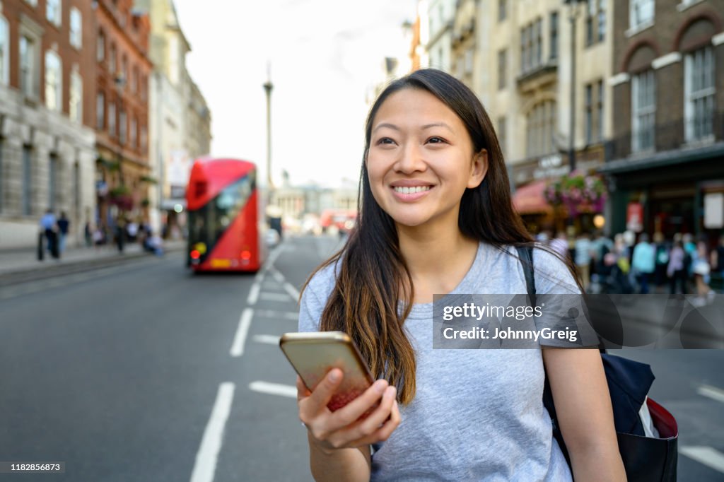 Chinese toerist in Londen het controleren van de Smart Phone voor begeleiding