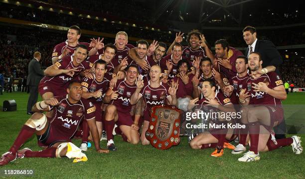 The Maroons team celebrate with the shield after winning game three of the ARL State of Origin series between the Queensland Maroons and the New...