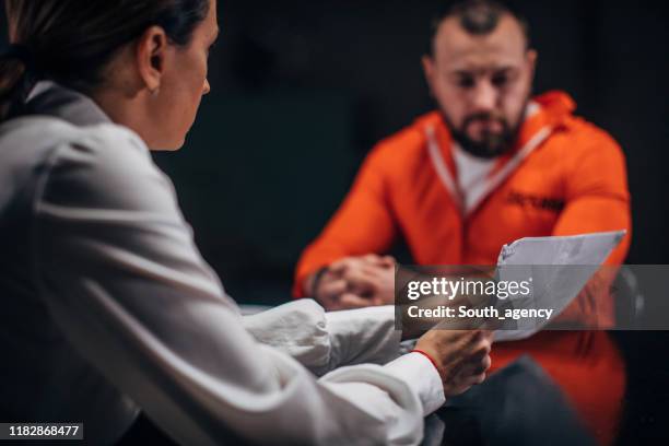 woman detective interrogating a prisoner in interrogation room - probation stock pictures, royalty-free photos & images