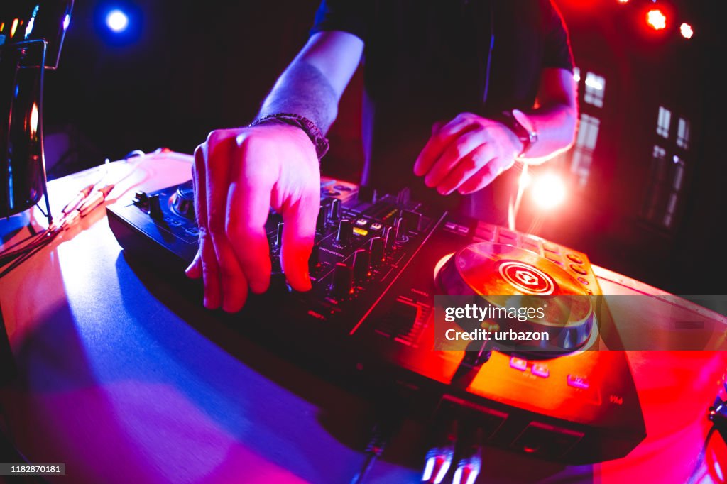 DJ playing and mixing music at party