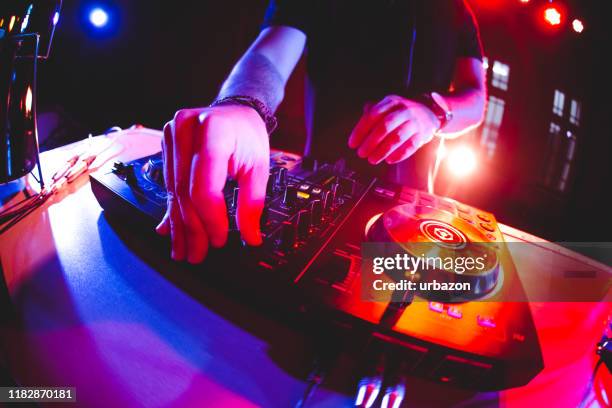 dj playing and mixing music at party - disc jockey stock pictures, royalty-free photos & images