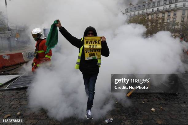 'Gilets Jaunes' protesters clash with French riot police on Place d'Italie during a protest to mark the first anniversary of the ''yellow vest''...