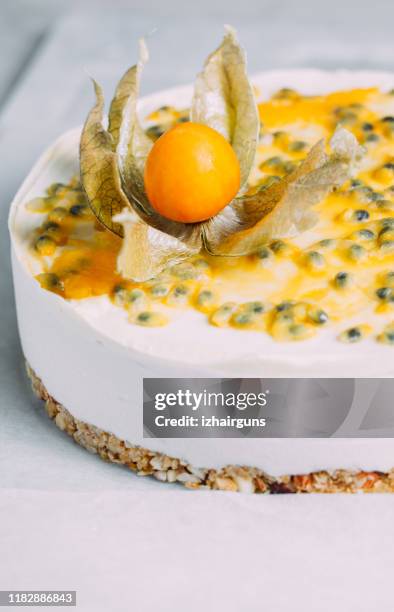 passionfruit vegan cheesecake with physalis on marble background with copy space - winter cherry stock pictures, royalty-free photos & images