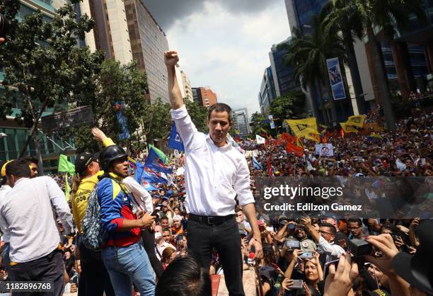 Opposition leader Juan Guaido, recognized by many members of the international community as the country's rightful interim ruler, greets supporters...