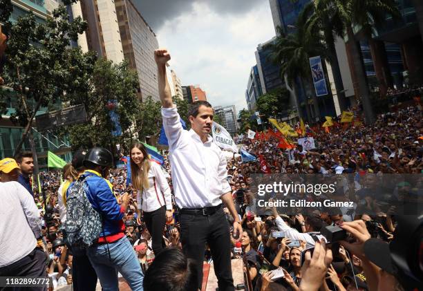 Opposition leader Juan Guaido, recognized by many members of the international community as the country's rightful interim ruler, greets supporters...