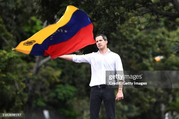 Opposition leader Juan Guaido, recognized by many members of the international community as the country's rightful interim ruler, waves a Venezuelan...