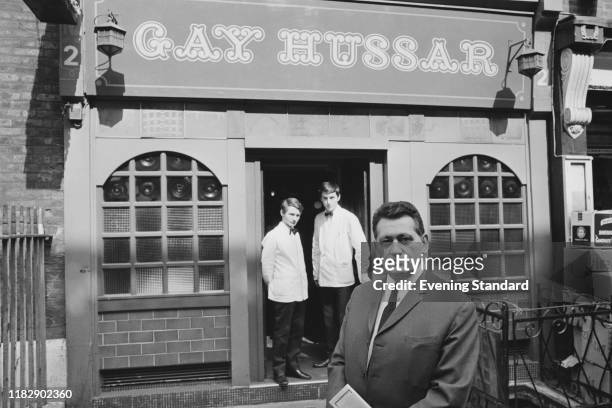 Victor Sassie and two waiters outside his restaurant, The Gay Hussar, in Soho, London, UK, 18th May 1970.