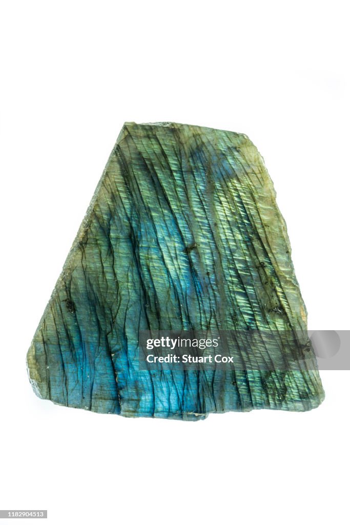 Polished labradorite slice on a white background.