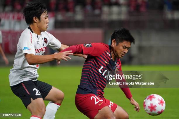 Daiya Tono of Honda FC and Yasushi Endo of Kashima Antlers compete for the ball during the 99th Emperor's Cup Quarter Final between Kashima Antlers...