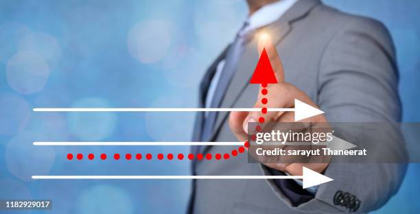 business different direction the hand of a business man is pointing to a business change point - new direction stock pictures, royalty-free photos & images