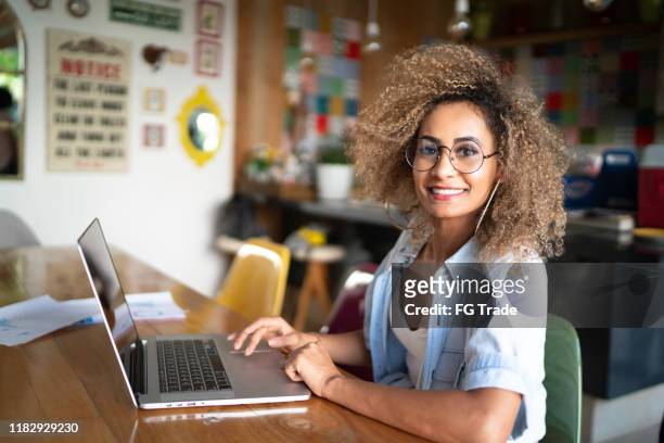 porträtt av mid adult woman med bärbar dator hemma - woman portrait kitchen laptop bildbanksfoton och bilder