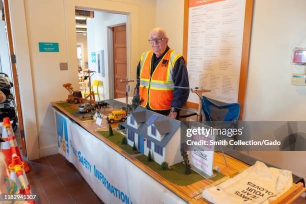 An employee of Pacific Gas and Electric Company uses a diorama to demonstrate risks associated with electrical power lines during a public safety...