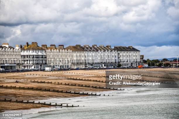 apartment buildings near the beach and waterfront of eastbourne, uk - sussex autumn stock pictures, royalty-free photos & images
