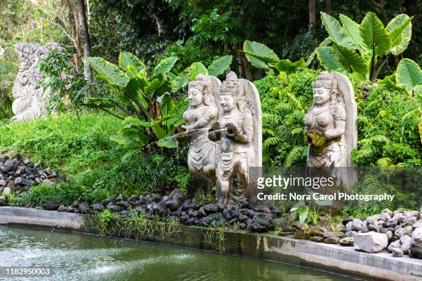 garden with statues in ubud monkey forest - ubud monkey forest stock pictures, royalty-free photos & images