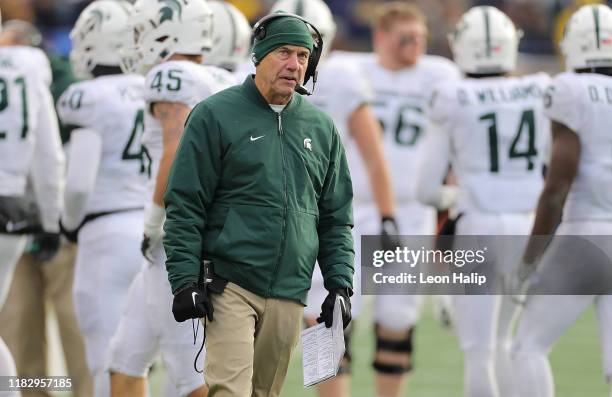 Michigan State Spartans head football coach Mark Dantonio watches the replay late in the fourth quarter of the game against the Michigan Wolverines...