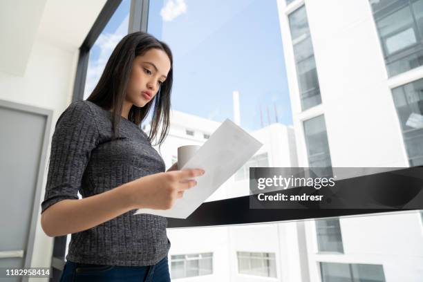 serious business woman reading documents at the office - lawyers serious stock pictures, royalty-free photos & images