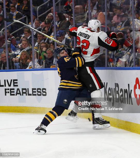 Conor Sheary of the Buffalo Sabres finishes his check on Nikita Zaitsev of the Ottawa Senators during the second period of play at KeyBank Center on...