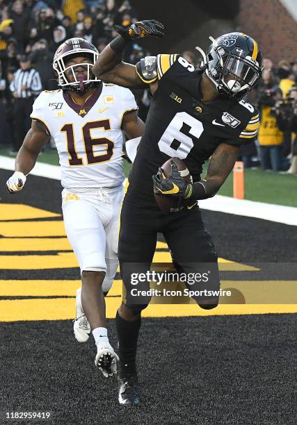 Iowa Hawkeyes wide receiver Ihmir Smith-Marsette celebrates after catching a pass for a touchdown as Minnesota linebacker Coney Durr looks on during...