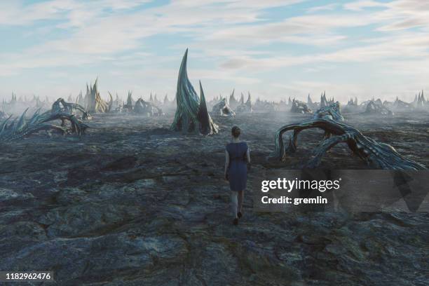 lost businesswoman walking in spooky badlands - dead landscape stock pictures, royalty-free photos & images