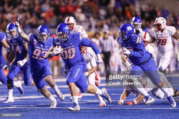 Nose tackle Sonatane Lui of the Boise State Broncos recovers a fumble on the first play from scrimmage and returns the ball for a touchdown during...