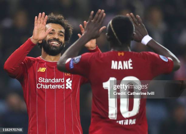 Mohamed Salah of Liverpool celebrates with teammate Sadio Mane after scoring his team's fourth goal during the UEFA Champions League group E match...